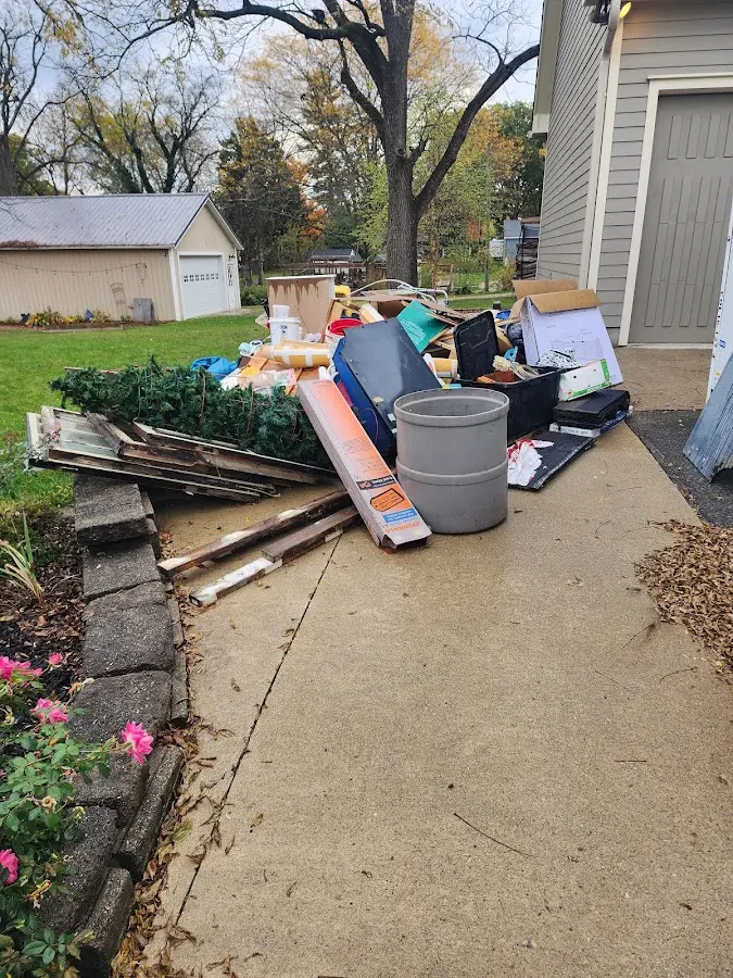 Dumpster being loaded with debris for Roofing Dumpster Rental in Zapata